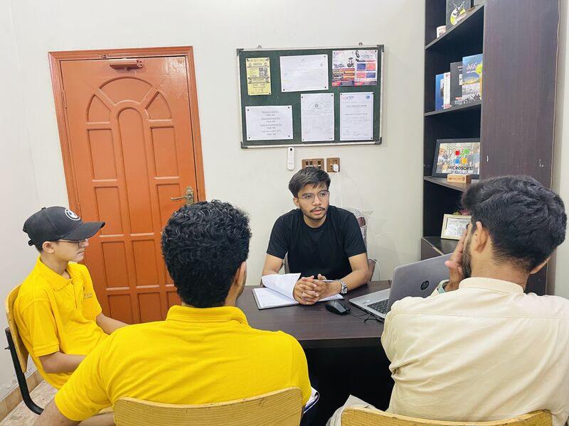 Rosetech team seated around a table during a strategy meeting